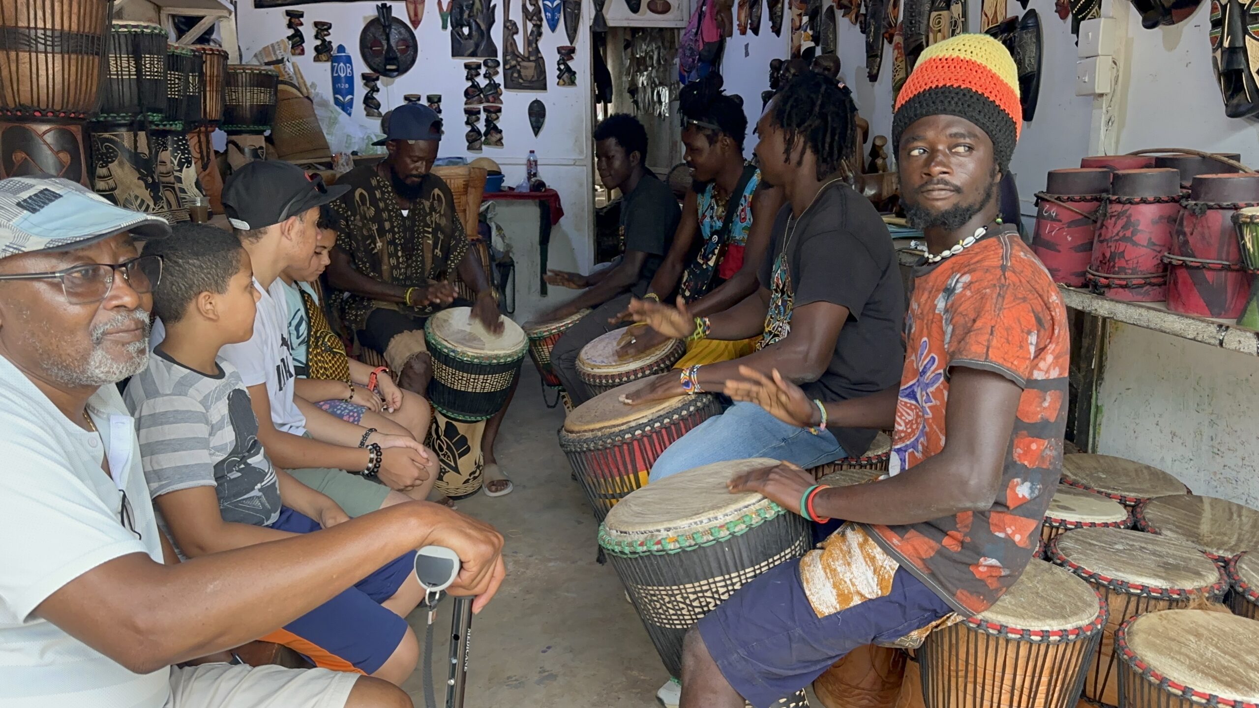 The Wander Crew learning to play drums at the Accra Art Market in Ghana
